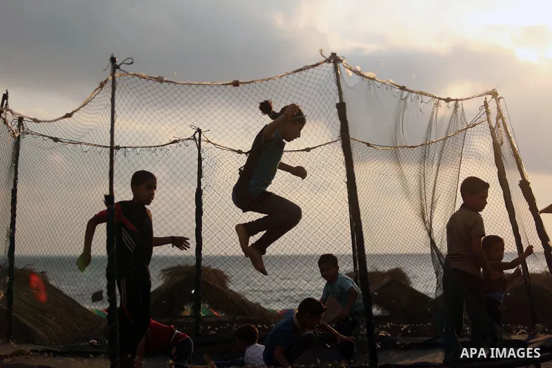 Palestinians enjoy their time at the beach of the Mediterranean sea on the coast of Gaza city, on June 30, 2017. Photo by Ashraf Amra