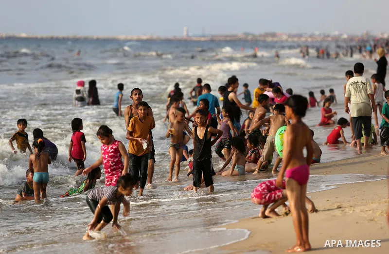 Palestinians enjoy their time at the beach of the Mediterranean sea on the coast of Gaza city, on June 30, 2017. Photo by Ashraf Amra