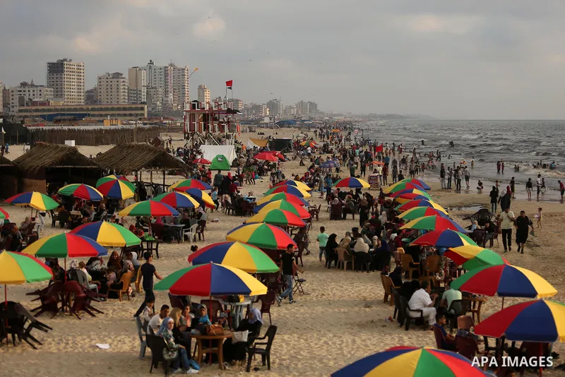 Palestinians enjoy their time at the beach of the Mediterranean sea on the coast of Gaza city, on June 30, 2017. Photo by Ashraf Amra
