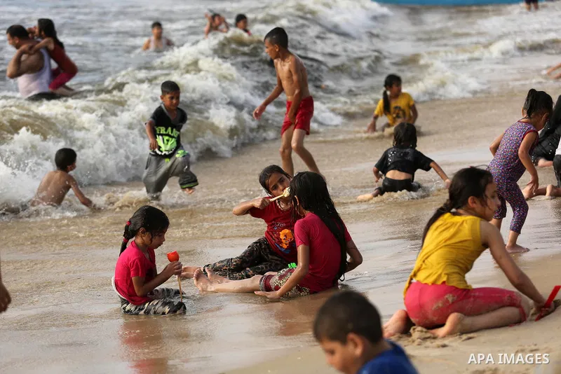 Palestinians enjoy their time at the beach of the Mediterranean sea on the coast of Gaza city, on June 30, 2017. Photo by Ashraf Amra