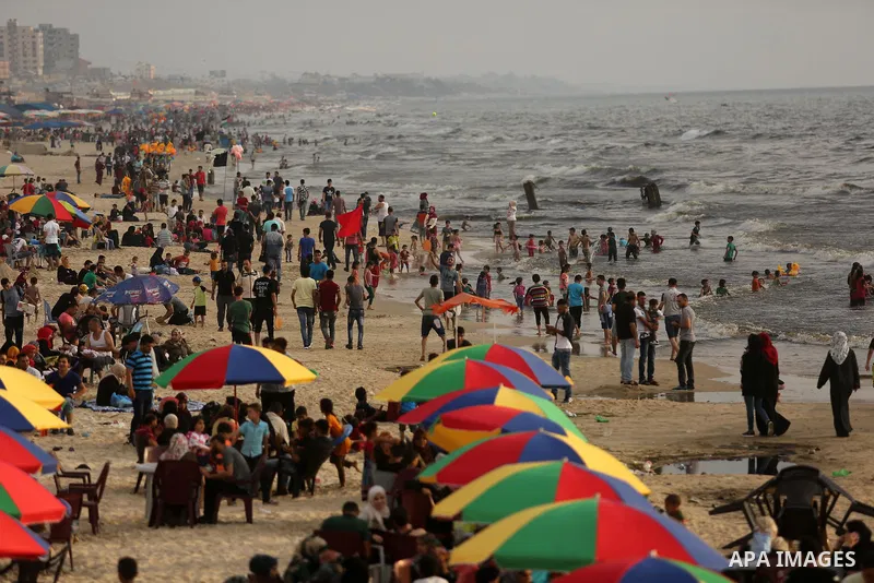 Palestinians enjoy their time at the beach of the Mediterranean sea on the coast of Gaza city, on June 30, 2017. Photo by Ashraf Amra