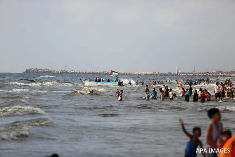 Palestinians enjoy their time at the beach of the Mediterranean sea on the coast of Gaza city, on June 30, 2017. Photo by Ashraf Amra
