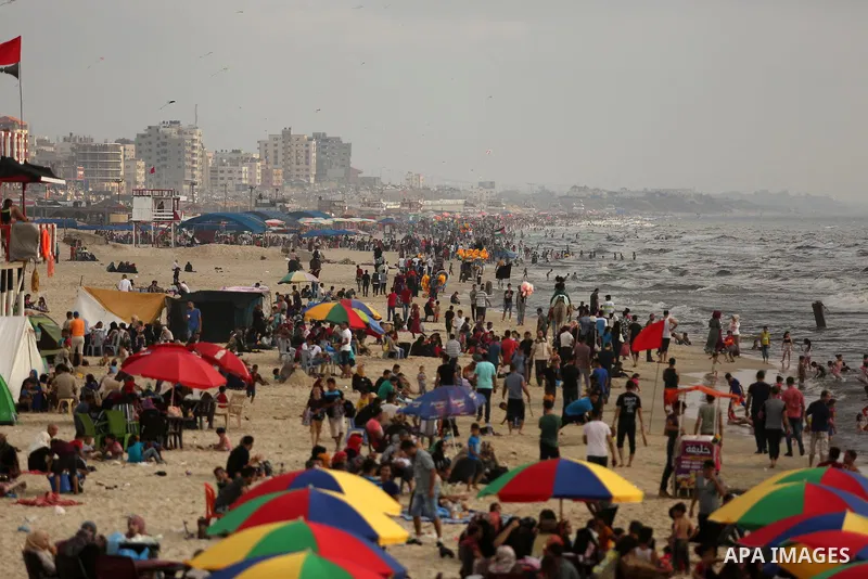 Palestinians enjoy their time at the beach of the Mediterranean sea on the coast of Gaza city, on June 30, 2017. Photo by Ashraf Amra