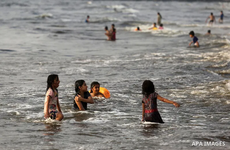 Palestinians enjoy their time at the beach of the Mediterranean sea on the coast of Gaza city, on June 30, 2017. Photo by Ashraf Amra