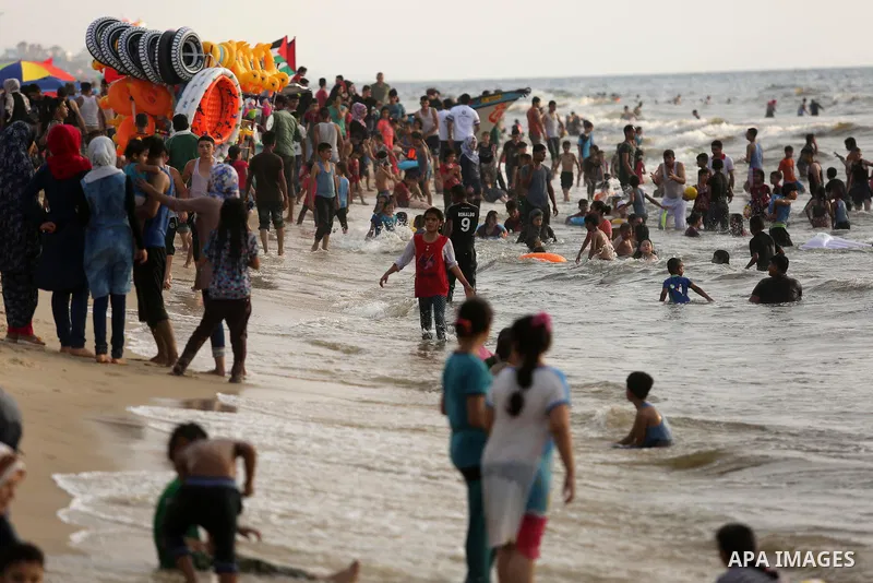Palestinians enjoy their time at the beach of the Mediterranean sea on the coast of Gaza city, on June 30, 2017. Photo by Ashraf Amra