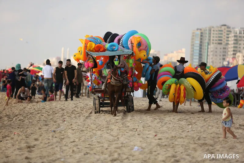 Palestinians enjoy their time at the beach of the Mediterranean sea on the coast of Gaza city, on June 30, 2017. Photo by Ashraf Amra