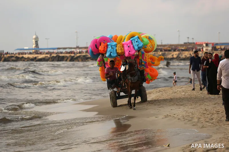 Palestinians enjoy their time at the beach of the Mediterranean sea on the coast of Gaza city, on June 30, 2017. Photo by Ashraf Amra