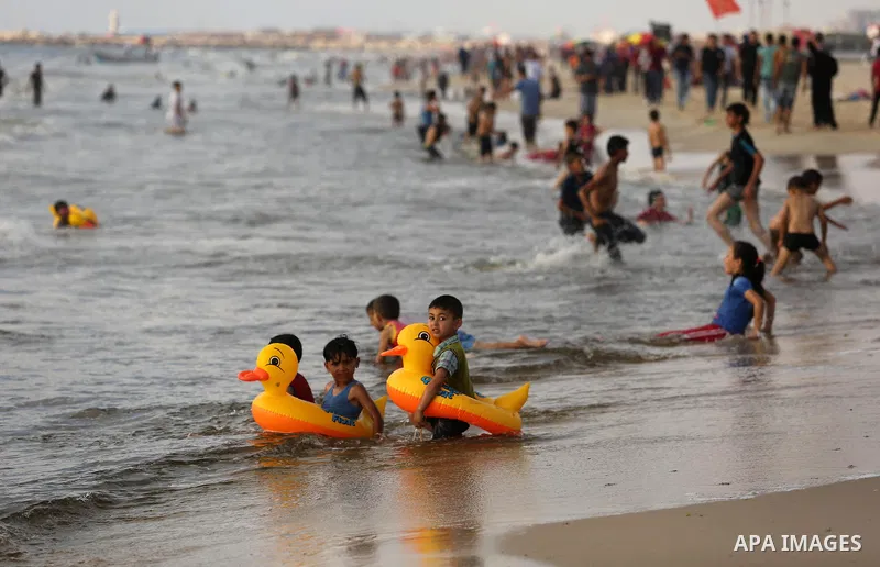 Palestinians enjoy their time at the beach of the Mediterranean sea on the coast of Gaza city, on June 30, 2017. Photo by Ashraf Amra