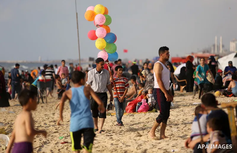 Palestinians enjoy their time at the beach of the Mediterranean sea on the coast of Gaza city, on June 30, 2017. Photo by Ashraf Amra