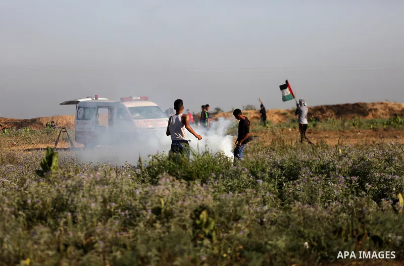 Palestinian protesters run for cover during clashes with Israeli security forces near the border fence east of Gaza City, on July 02, 2017. Photo by Mohammed Asad