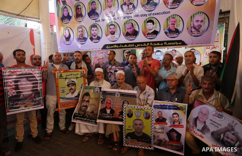 Palestinians take part in a protest to show solidarity with Palestinian prisoners held in Israeli jails, in front of Red cross office in Gaza city on July 3, 2017. Photo by Mohammed Asad