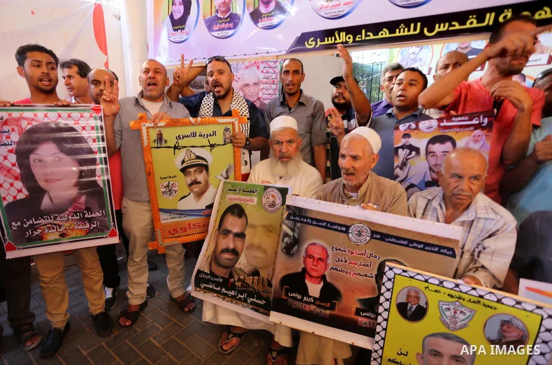 Palestinians take part in a protest to show solidarity with Palestinian prisoners held in Israeli jails, in front of Red cross office in Gaza city on July 3, 2017. Photo by Mohammed Asad