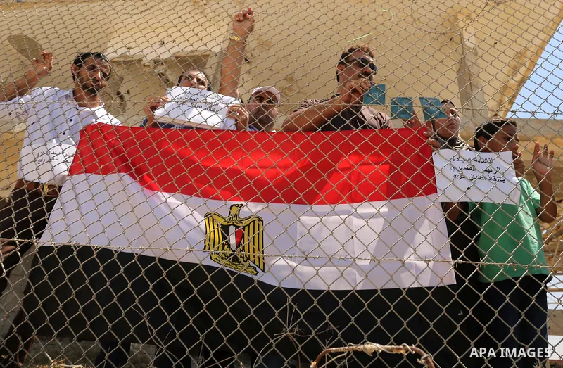 Palestinians gather in front of the gate of Rafah border crossing between Egypt and Gaza during a protest against the blockade calling for reopening of the crossing, in the southern Gaza Strip July 3, 2017. Photo by Ashr...