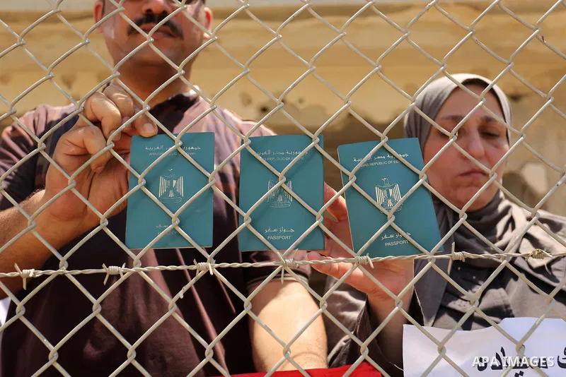 Palestinians gather in front of the gate of Rafah border crossing between Egypt and Gaza during a protest against the blockade calling for reopening of the crossing, in the southern Gaza Strip July 3, 2017. Photo by Ashr...