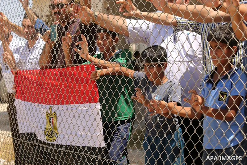 Palestinians gather in front of the gate of Rafah border crossing between Egypt and Gaza during a protest against the blockade calling for reopening of the crossing, in the southern Gaza Strip July 3, 2017. Photo by Ashr...