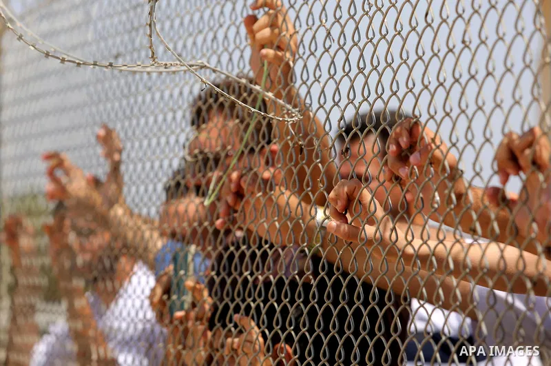 Palestinians gather in front of the gate of Rafah border crossing between Egypt and Gaza during a protest against the blockade calling for reopening of the crossing, in the southern Gaza Strip July 3, 2017. Photo by Ashr...