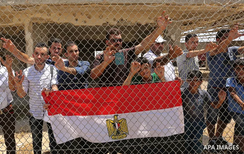Palestinians gather in front of the gate of Rafah border crossing between Egypt and Gaza during a protest against the blockade calling for reopening of the crossing, in the southern Gaza Strip July 3, 2017. Photo by Ashr...