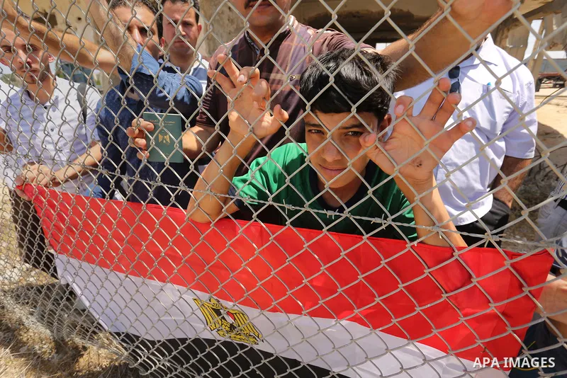 Palestinians gather in front of the gate of Rafah border crossing between Egypt and Gaza during a protest against the blockade calling for reopening of the crossing, in the southern Gaza Strip July 3, 2017. Photo by Ashr...