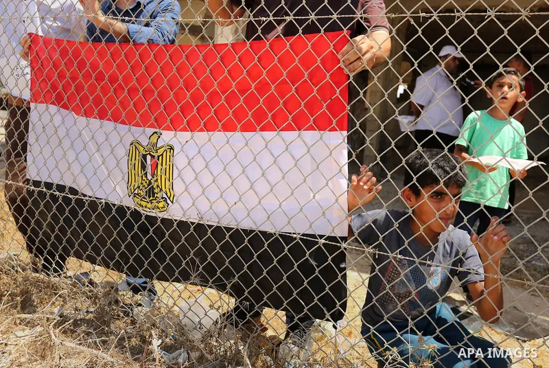 Palestinians gather in front of the gate of Rafah border crossing between Egypt and Gaza during a protest against the blockade calling for reopening of the crossing, in the southern Gaza Strip July 3, 2017. Photo by Ashr...