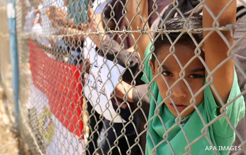 Palestinians gather in front of the gate of Rafah border crossing between Egypt and Gaza during a protest against the blockade calling for reopening of the crossing, in the southern Gaza Strip July 3, 2017. Photo by Ashr...