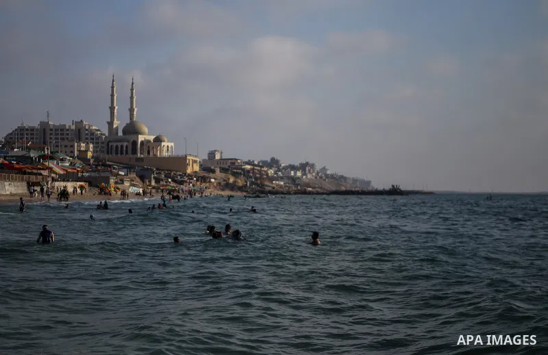 Palestinians swim in the Mediterranean sea on the coast of Gaza city during a hot day on July 3, 2017. Photo by Majd Hajjar