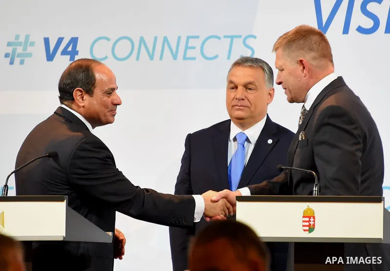 Hungarian Prime Minister Viktor Orban looks on as Egyptian President Abdel Fattah al-Sisi and Slovakian Prime Minister Robert Fico shake hands ahead of a joint press conference in Budapest on July 4, 2017 during a summit...