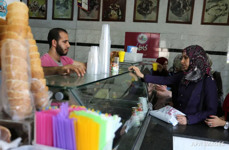 Palestinians buy ice-cream (sundae) during a heatwave in Gaza city on July 4, 2017. Photo by Ashraf Amra