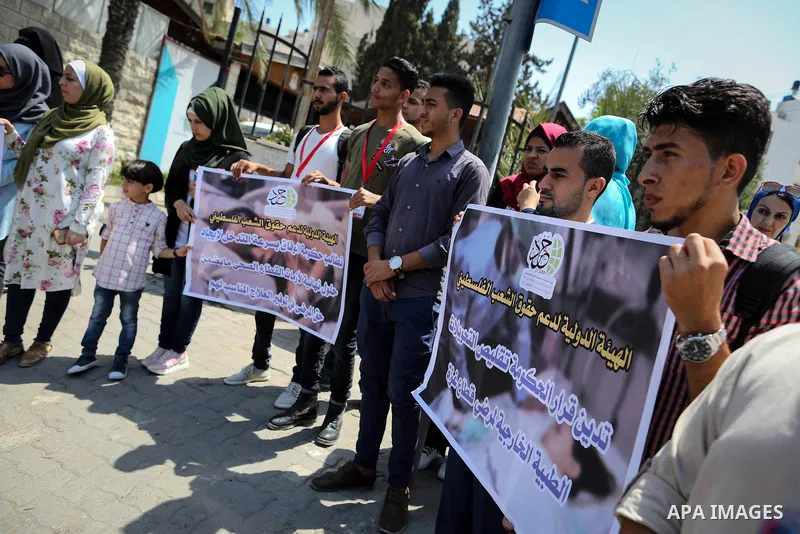 Palestinians take part in a protest against Israeli blockade and demanding to travel for treatment, in front of the Council of Ministers headguarter in Gaza city on July 5, 2017. Hamas accused the Palestinian Authority a...