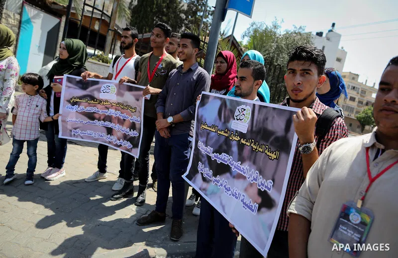 Palestinians take part in a protest against Israeli blockade and demanding to travel for treatment, in front of the Council of Ministers headguarter in Gaza city on July 5, 2017. Hamas accused the Palestinian Authority a...