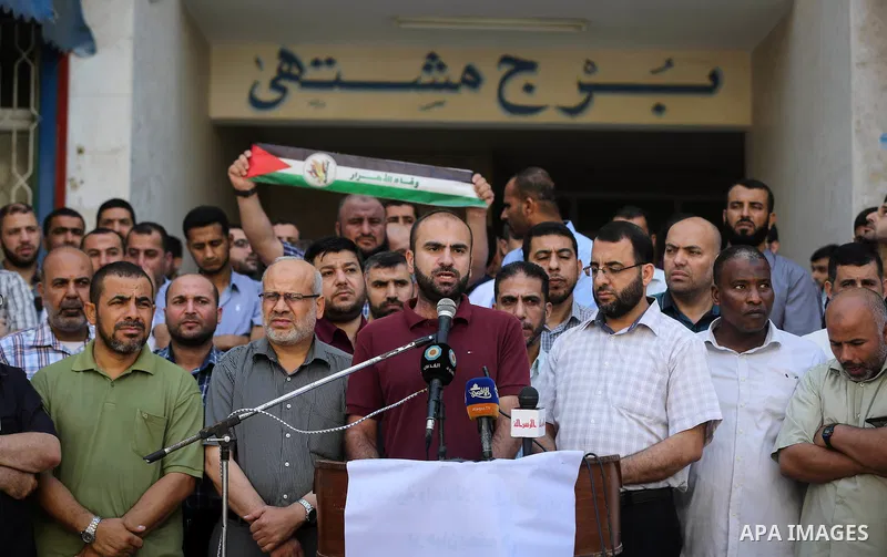Palestinians take part in a protest demanding their salaries in Gaza city on July 5, 2017. Photo by Ashraf Amra