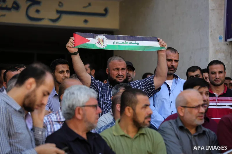 Palestinians take part in a protest demanding their salaries in Gaza city on July 5, 2017. Photo by Ashraf Amra
