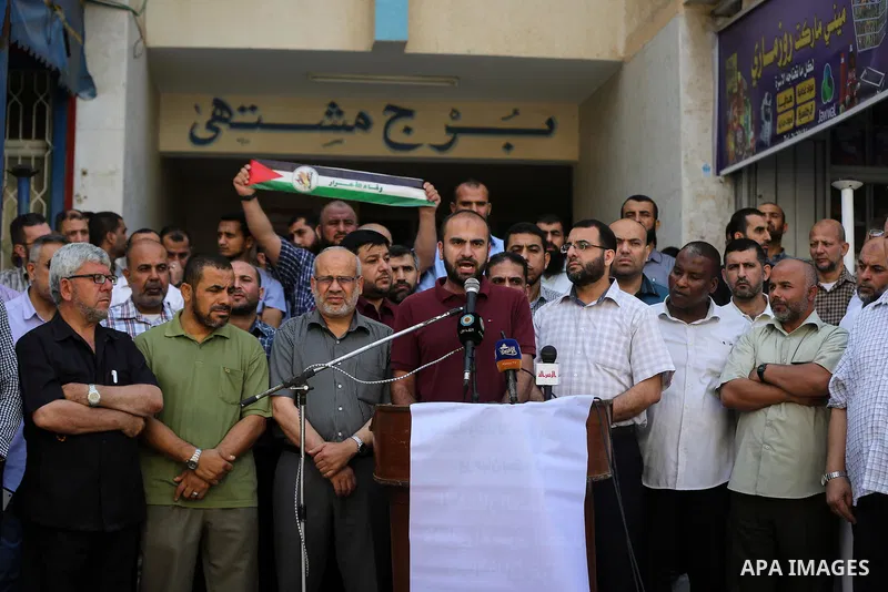 Palestinians take part in a protest demanding their salaries in Gaza city on July 5, 2017. Photo by Ashraf Amra