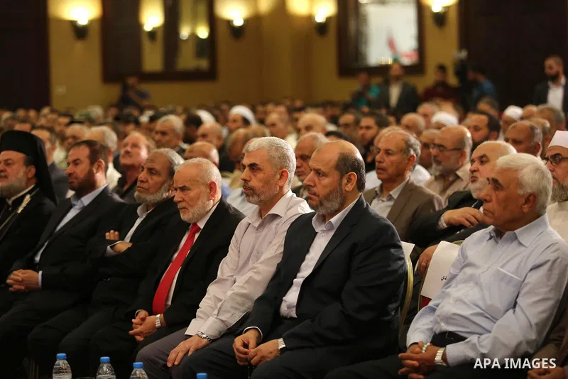 Yahya Sinwar the new leader of the Hamas Islamist movement in the Gaza Strip listens to a speech delivered by Hamas Chief Ismail Haniyeh in Gaza City on July 5, 2017. Haniya said that meetings between his movement and th...