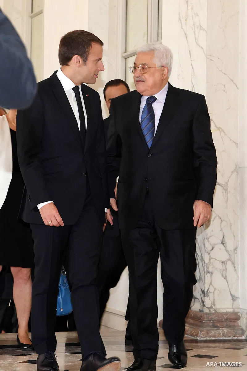 French President Emmanuel Macron greets Palestinian President Mahmoud Abbas prior to their meeting at the Elysee Palace in Paris, on July 5, 2017. Photo by Thaer Ganaim