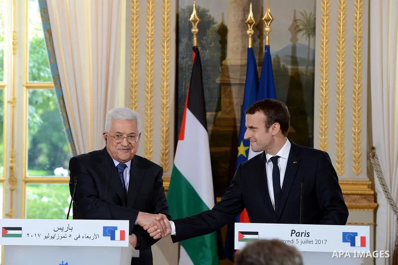 French President Emmanuel Macron shakes hands with Palestinian President Mahmoud Abbas, during a joint press conference following their meeting at the Elysee Palace in Paris, on July 5, 2017. Photo by Thaer Ganaim