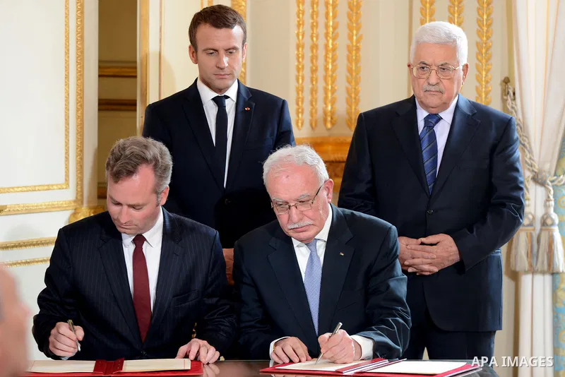 French Junior Foreign Affairs Minister Jean-Baptiste Lemoyne and Palestinian Foreign Minister Riyad Al-Maliki sign an agreement for the French International School in Ramallah as French President Emmanuel Macron and Pale...