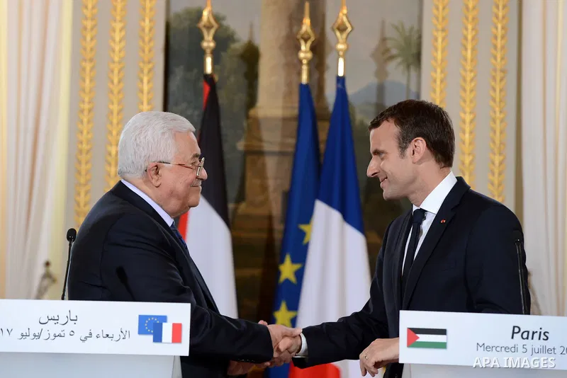 French President Emmanuel Macron shakes hands with Palestinian President Mahmoud Abbas, during a joint press conference following their meeting at the Elysee Palace in Paris, on July 5, 2017. Photo by Thaer Ganaim