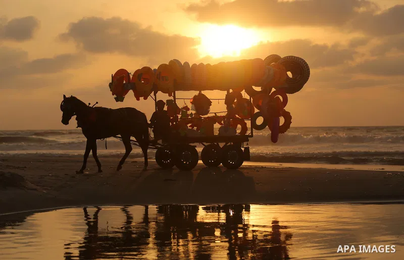 A Palestinian vendor rides his horse cart on the beach of Gaza city, on July 5, 2017. An immediate consequence of the electricity cuts has been suffering for Gazans. A new U.N. report said Gaza gets electricity just four...