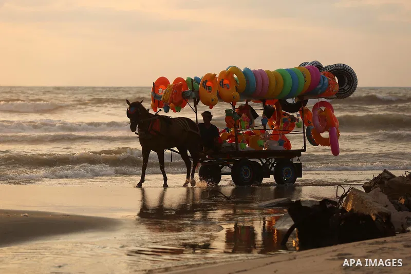 A Palestinian vendor rides his horse cart on the beach of Gaza city, on July 5, 2017. An immediate consequence of the electricity cuts has been suffering for Gazans. A new U.N. report said Gaza gets electricity just four...