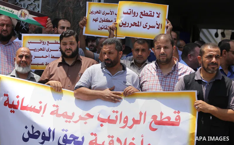 Palestinians take part in a protest demanding their salaries in Gaza city on July 6, 2017. Photo by Mohammed Asad