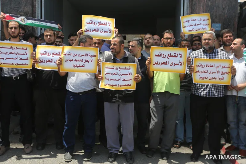 Palestinians take part in a protest demanding their salaries in Gaza city on July 6, 2017. Photo by Mohammed Asad