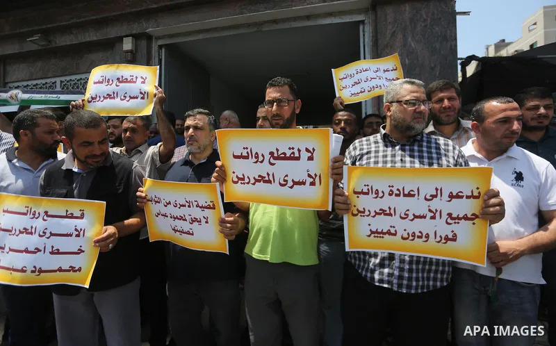 Palestinians take part in a protest demanding their salaries in Gaza city on July 6, 2017. Photo by Mohammed Asad