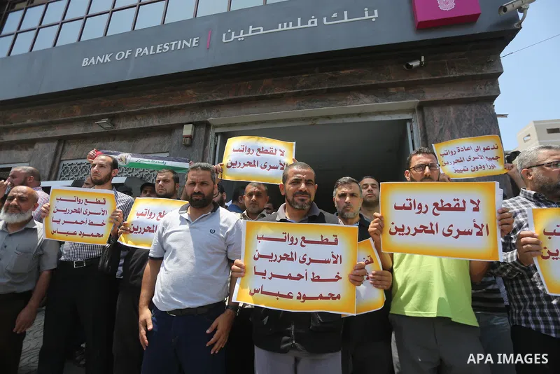 Palestinians take part in a protest demanding their salaries in Gaza city on July 6, 2017. Photo by Mohammed Asad