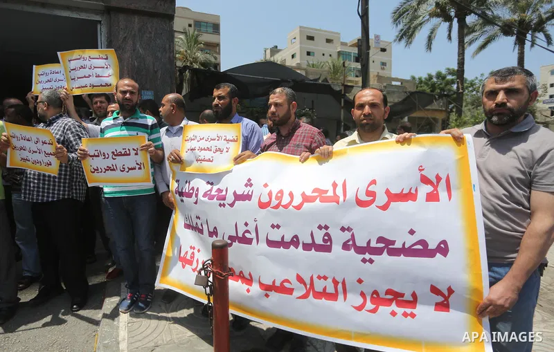 Palestinians take part in a protest demanding their salaries in Gaza city on July 6, 2017. Photo by Mohammed Asad