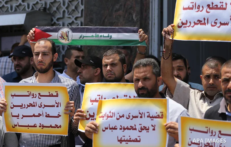 Palestinians take part in a protest demanding their salaries in Gaza city on July 6, 2017. Photo by Mohammed Asad