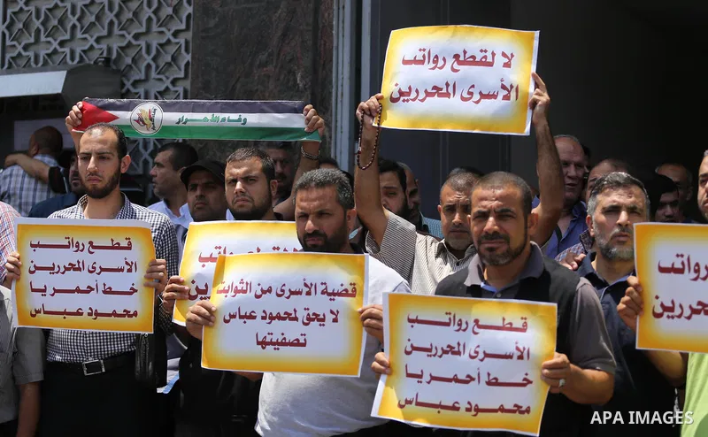 Palestinians take part in a protest demanding their salaries in Gaza city on July 6, 2017. Photo by Mohammed Asad