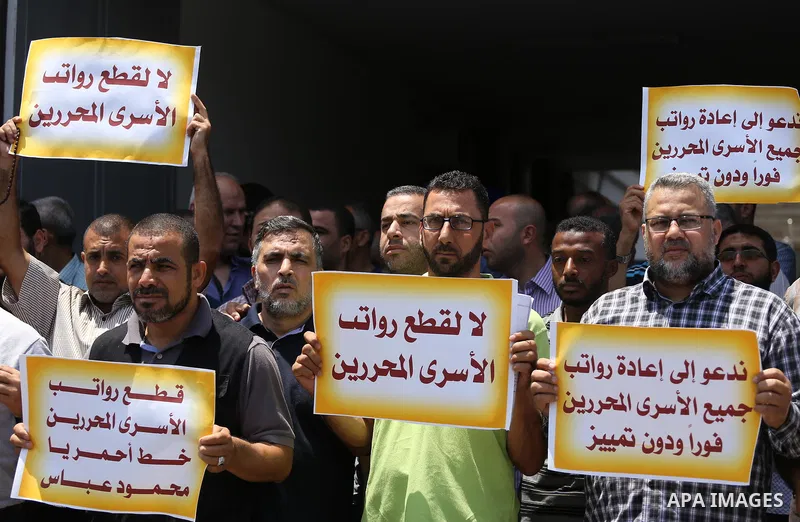 Palestinians take part in a protest demanding their salaries in Gaza city on July 6, 2017. Photo by Mohammed Asad