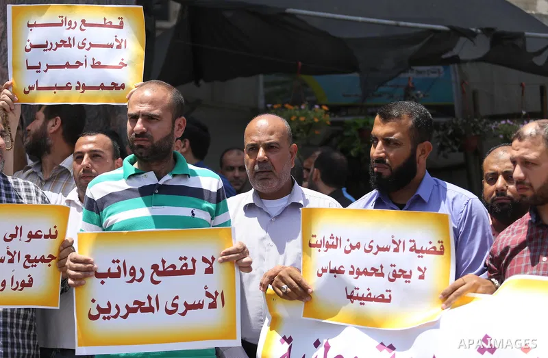 Palestinians take part in a protest demanding their salaries in Gaza city on July 6, 2017. Photo by Mohammed Asad