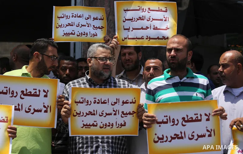 Palestinians take part in a protest demanding their salaries in Gaza city on July 6, 2017. Photo by Mohammed Asad