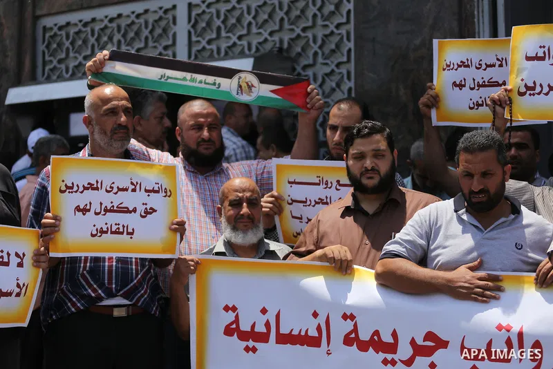 Palestinians take part in a protest demanding their salaries in Gaza city on July 6, 2017. Photo by Mohammed Asad